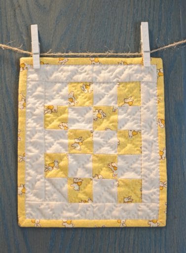 Yellow quilt on blue door