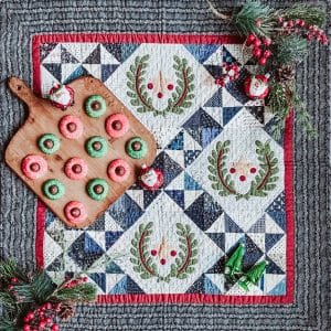 Pieced and applique Christmas quilt with peppermint cookies