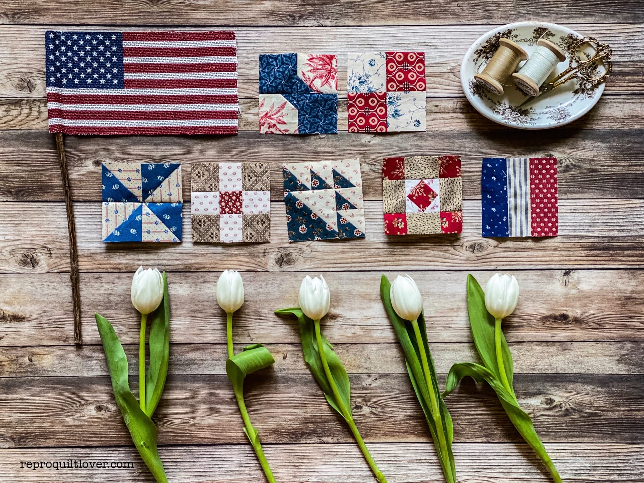 small square quilt blocks with flag and flowers on wood background