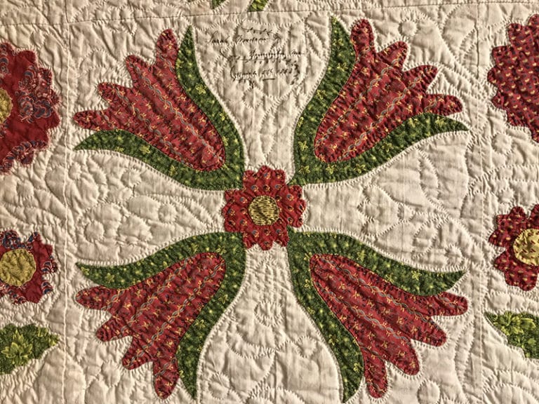 Detail of dated 1853 red and green antique quilt