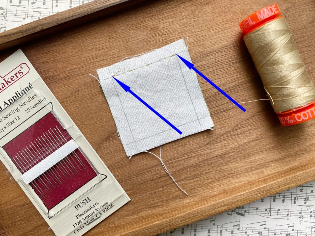 Hand stitch seam joining two squares