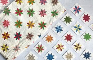 Antique quilt with pieced stars on a cream background with reproduction stars next to it