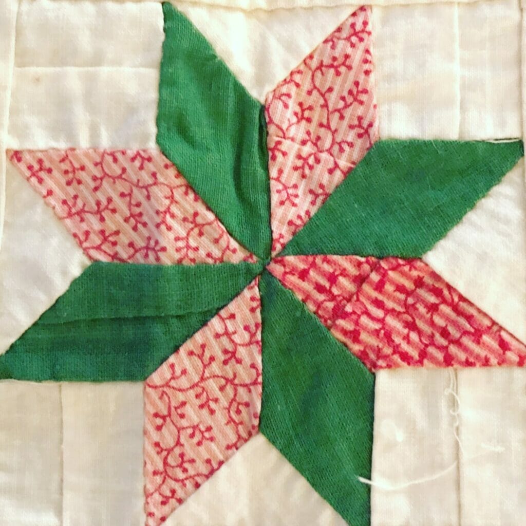 pieced Lemoyne star block in pink and green