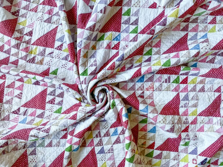 Multi color scrap quilt in the Lady of the Lake block pattern