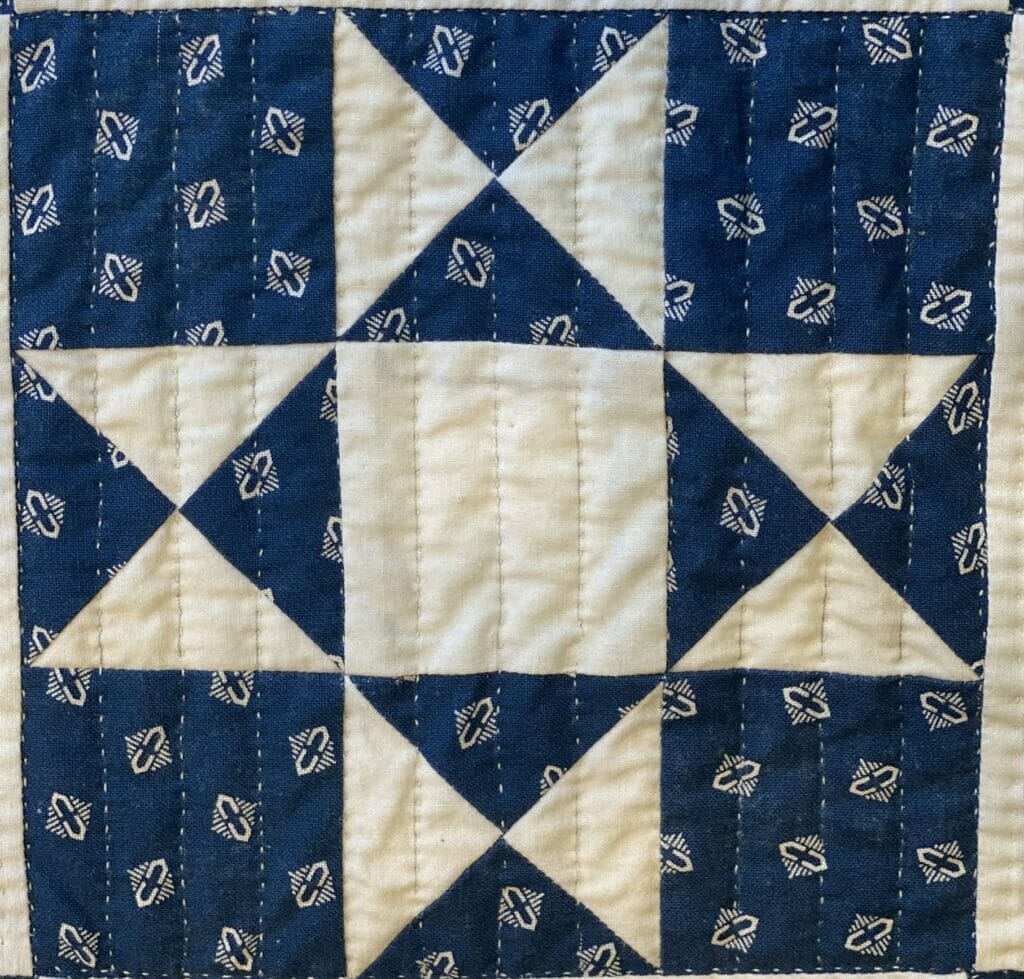 Blue and white Ohio Star quilt block