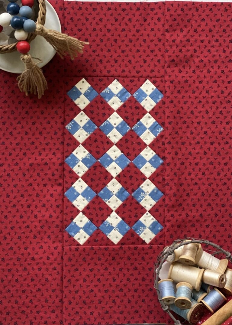 red white and blue quilt with blocks set on point
